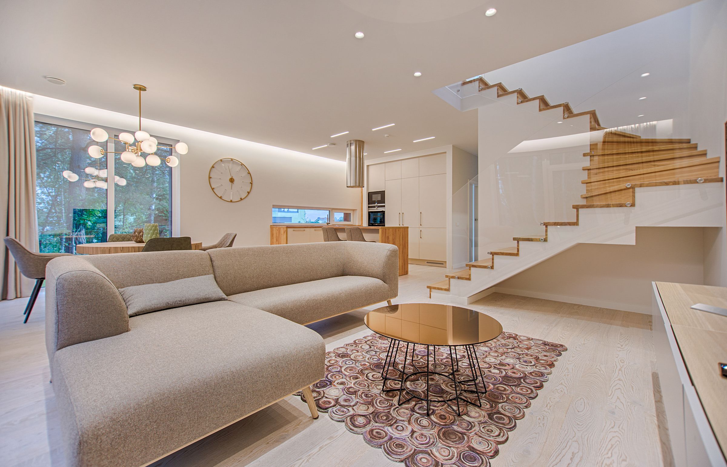Well-lit modern staircase with glass balustrade in an open-plan home near Inverurie and Blackburn