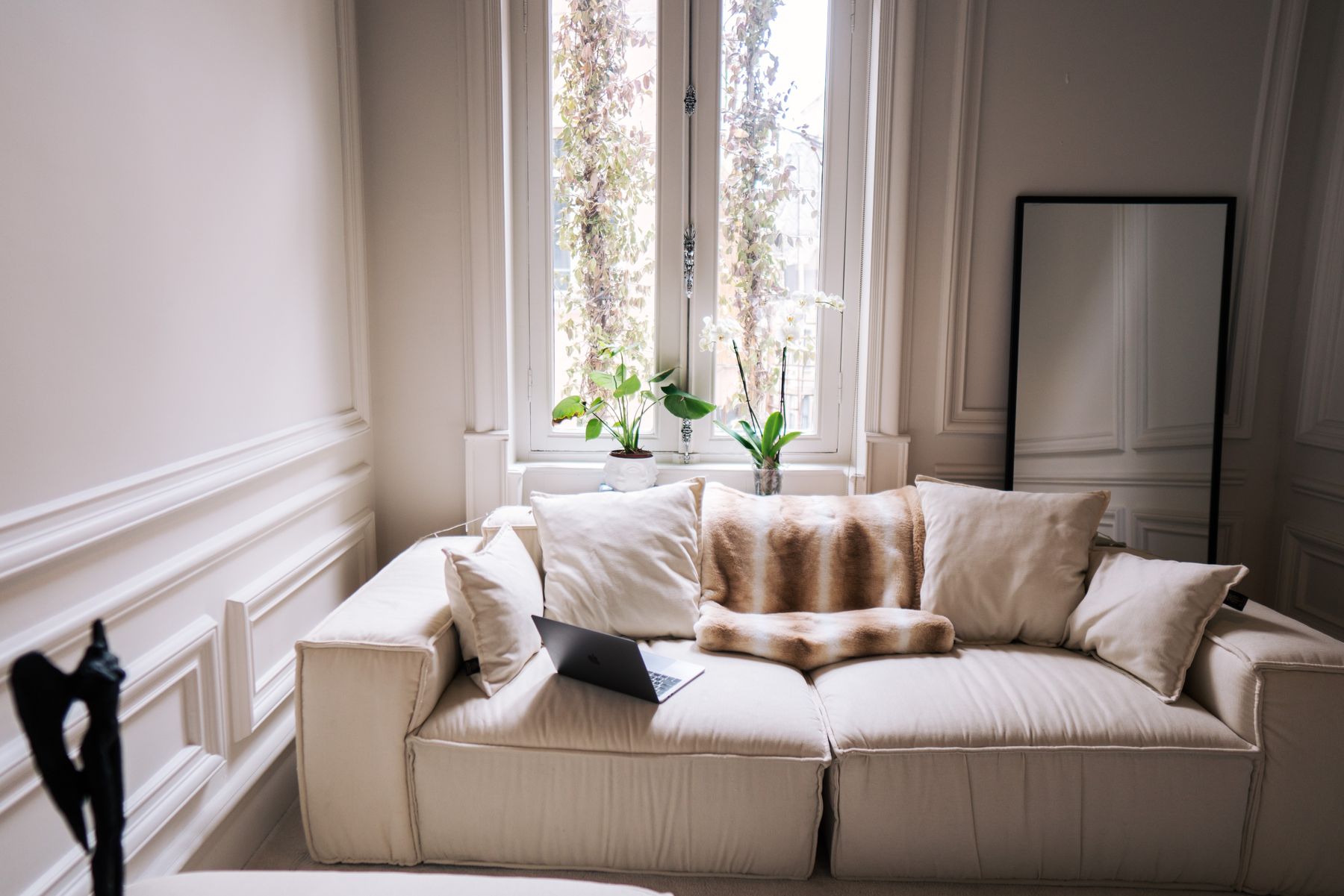 Bright living room with sash windows and a clean cream sofa in an upscale home near Newtonhill and Portlethen