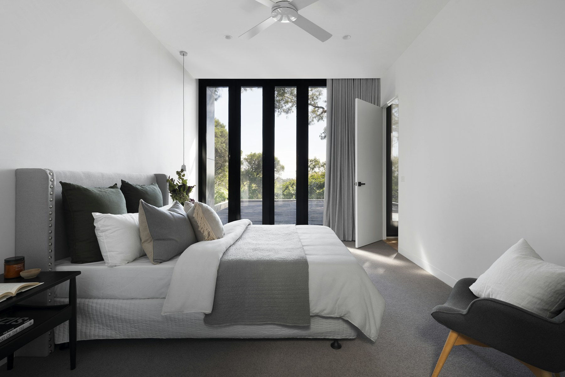 Premium bedroom with crisp bedding and floor-to-ceiling windows in an upscale home in Westhill